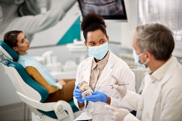 two-dentists-discussing-about-dental-health-of-the-2024-12-13-19-08-55-utc